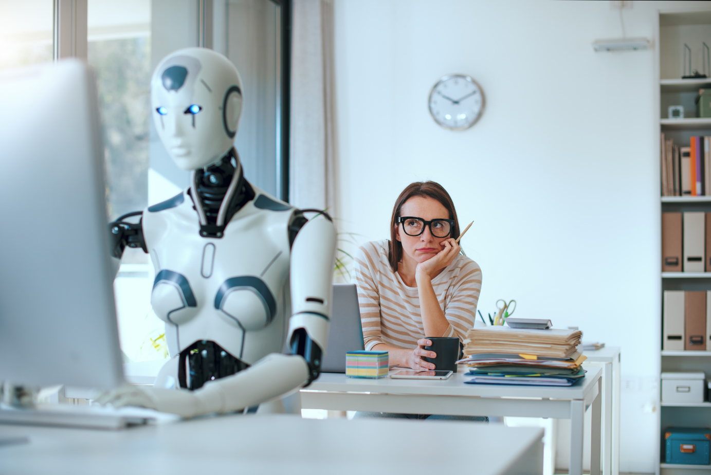 AI robot and human professional working together at a desk in a modern office
